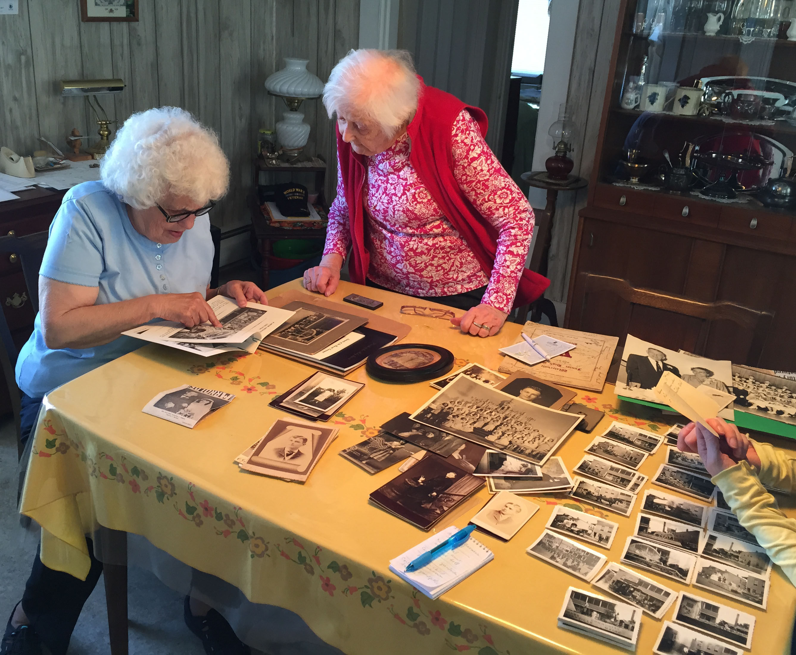 Therese Small (right) sharing her family photographs in her home on Gold Street, Waterville, Maine, with friend Connie Noonan, May 2015. Photograph by Tanya Sheehan (30097)