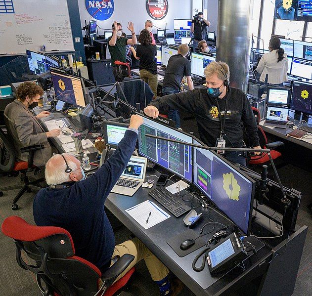NASA scientists celebrating the deployment of one of the telescope’s mirrors