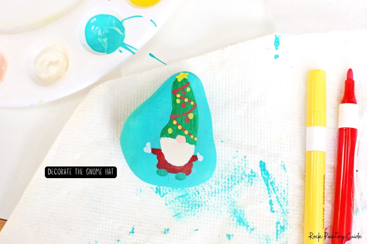 How To Make Adorable Christmas Gnome Painted Rocks 10 decorate the gnome hat on the gnome painted rock