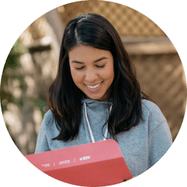 a woman reading an ace fitness personal trainer textbook located on the ace fitness personal trainer certification webpage