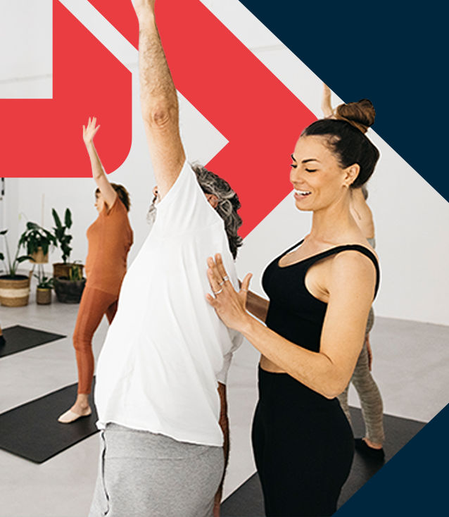 YogaRenew 200-Hour Yoga Teacher teaching a class of students how to perform yoga poses