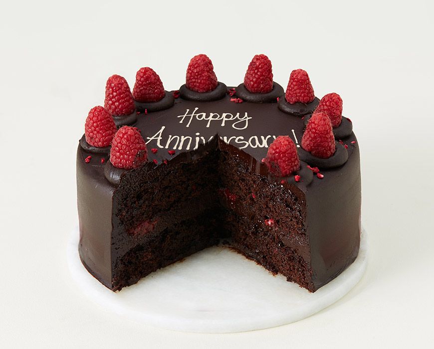 Celebrating wedding anniversary with heart shape chocolate cake Stock Photo  - Alamy