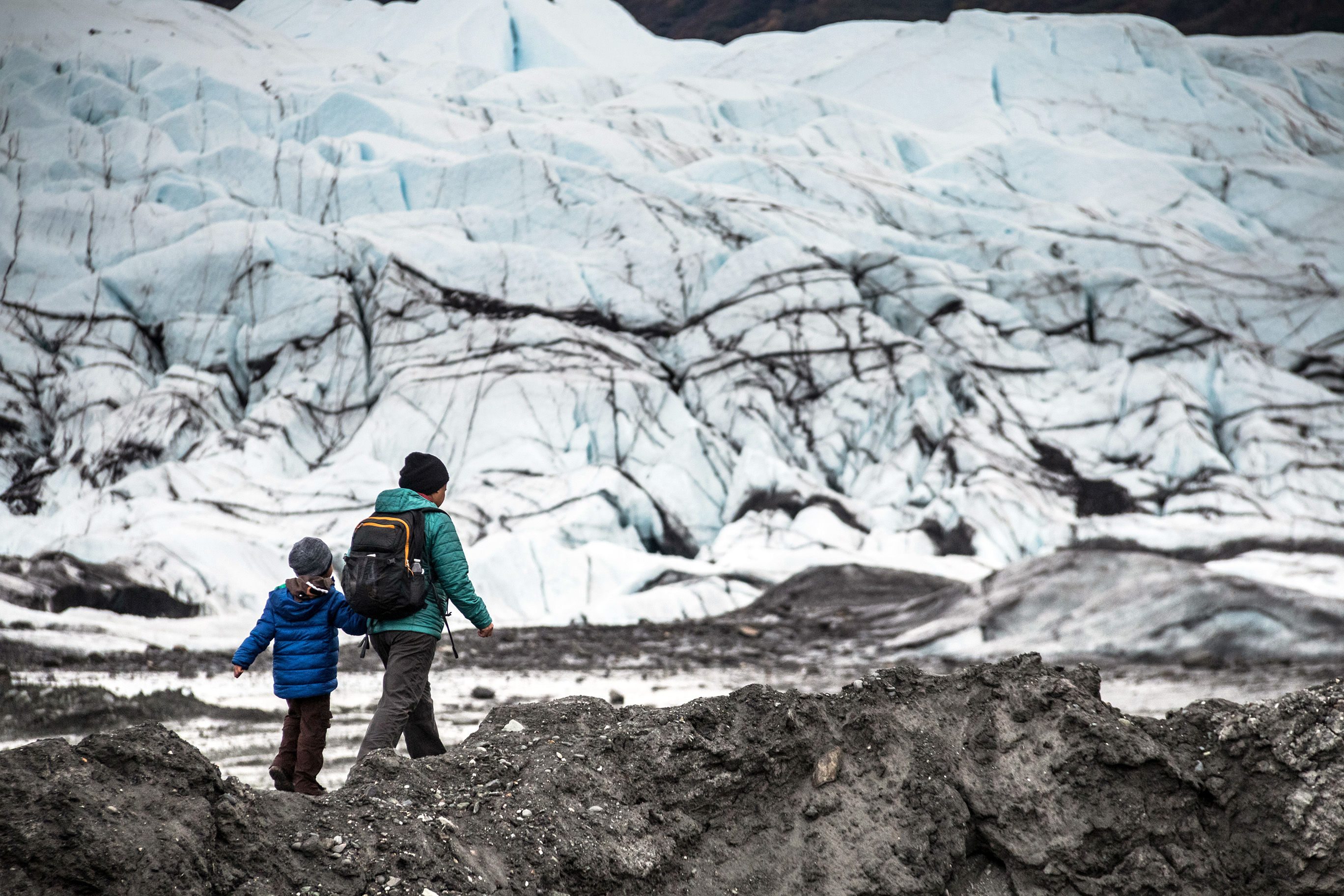 Mother and son hiking on glacier