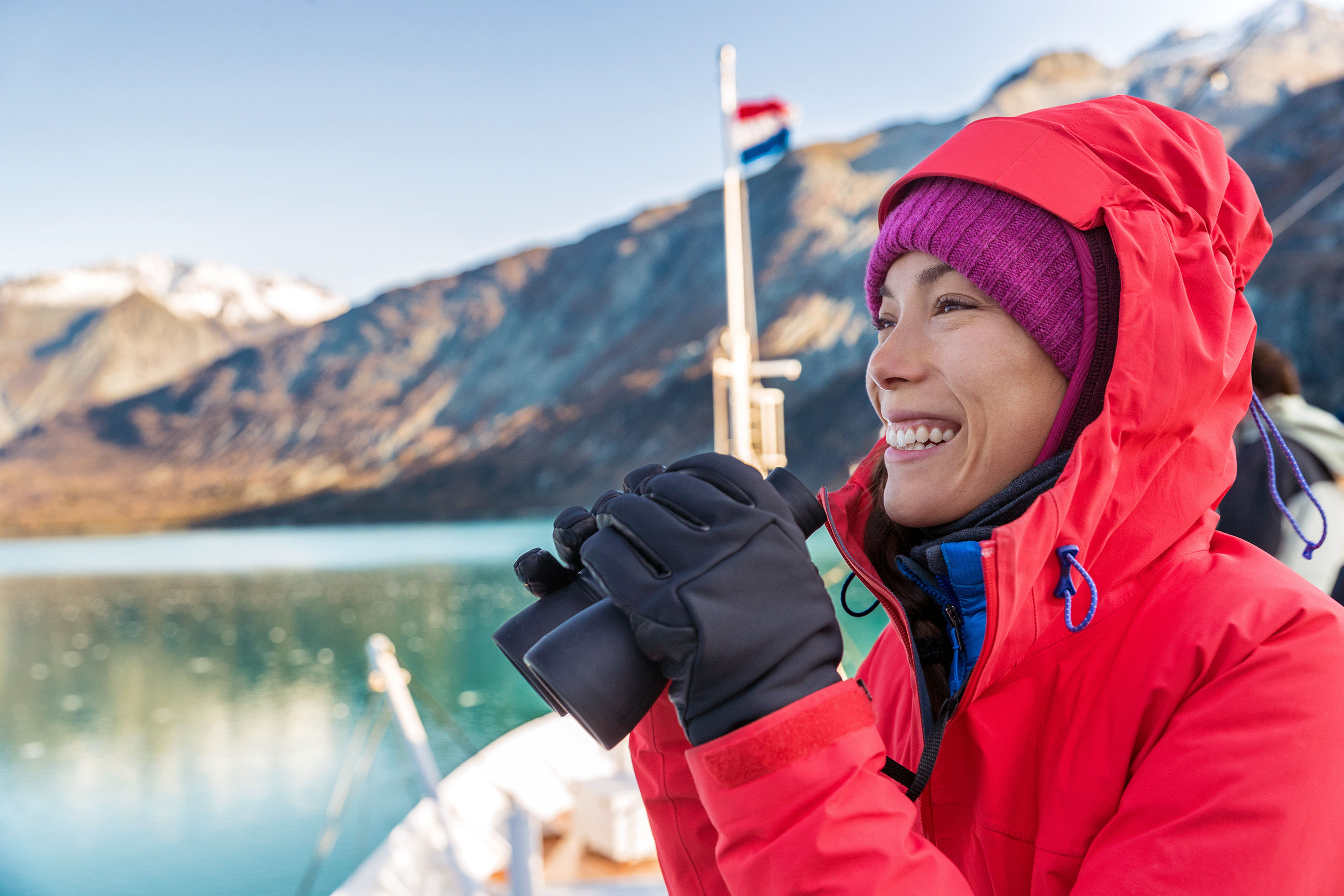 Woman with binoculars on Alaska cruise