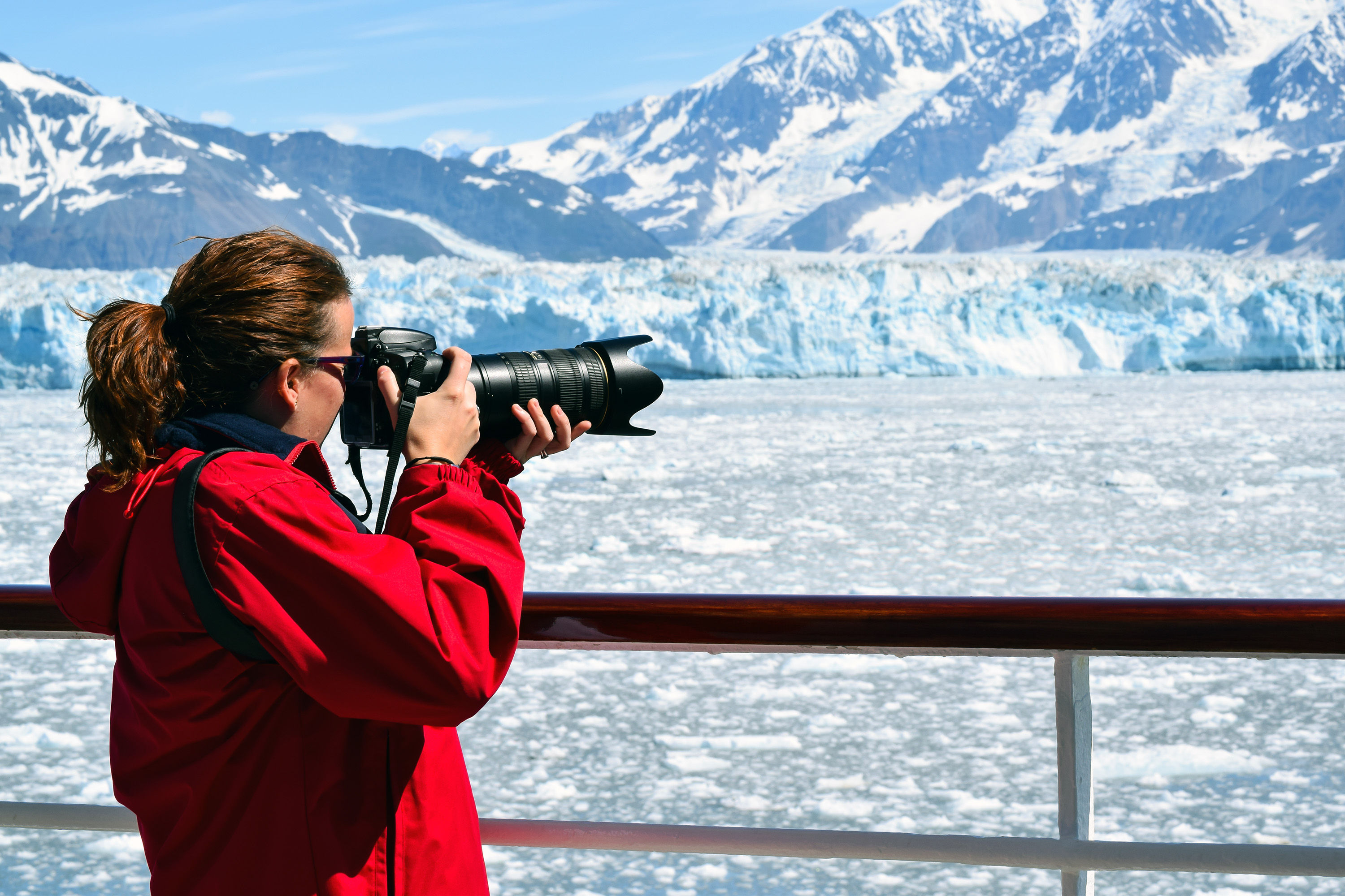 Woman photographing Hubbard Glacier