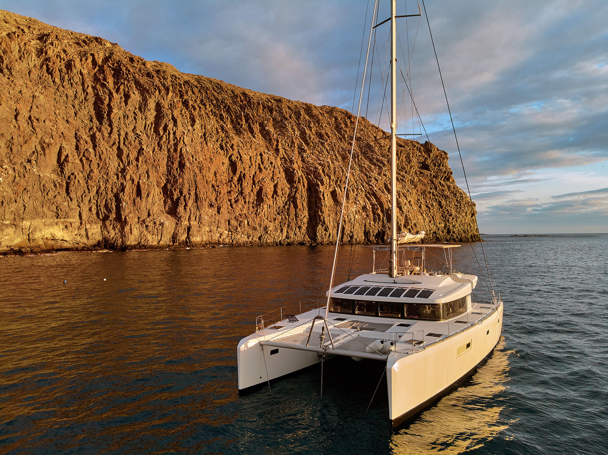 Catamaran near cliffs in Tenerife, Canary Islands