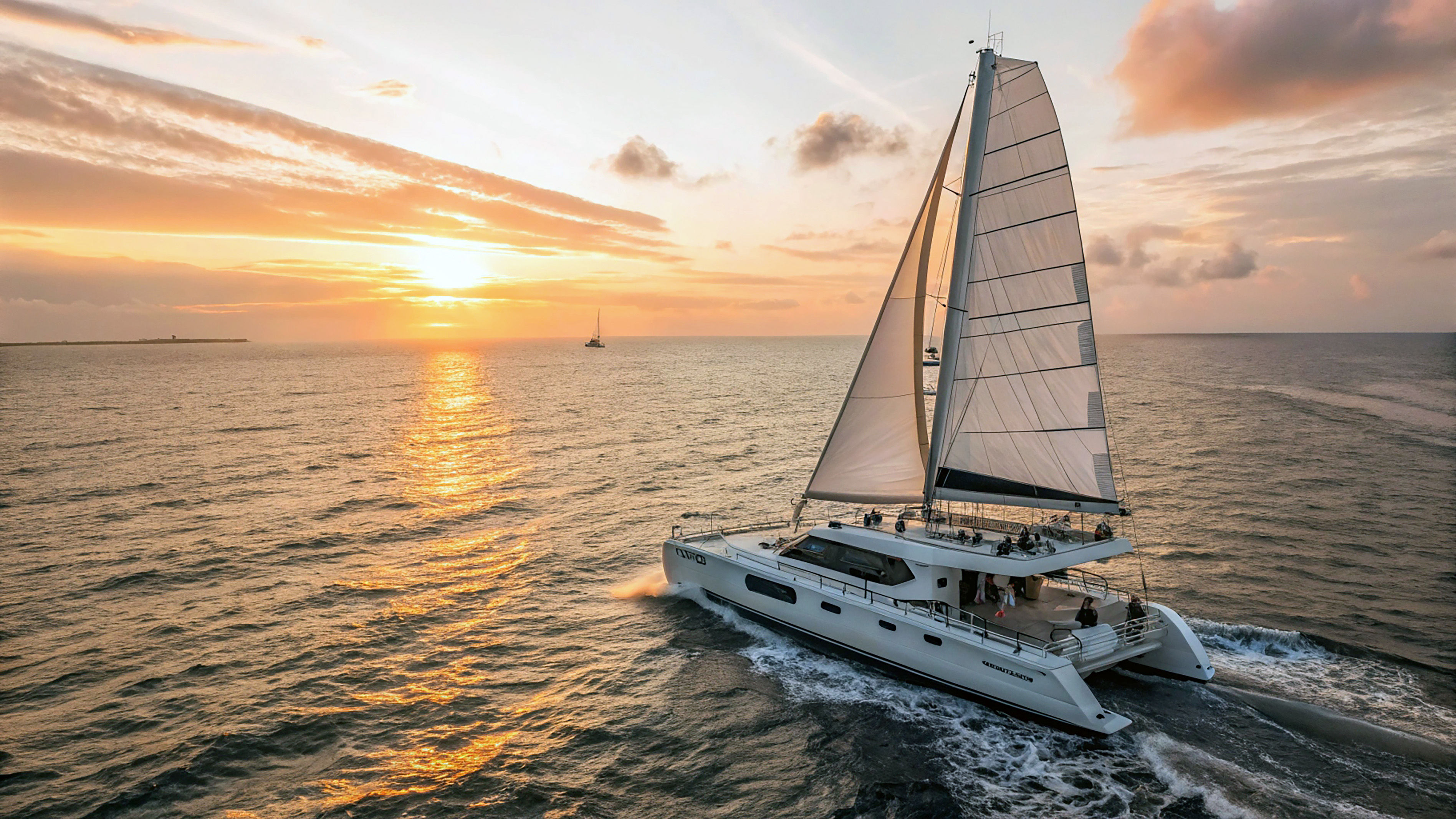 Catamaran sailing into the sunset