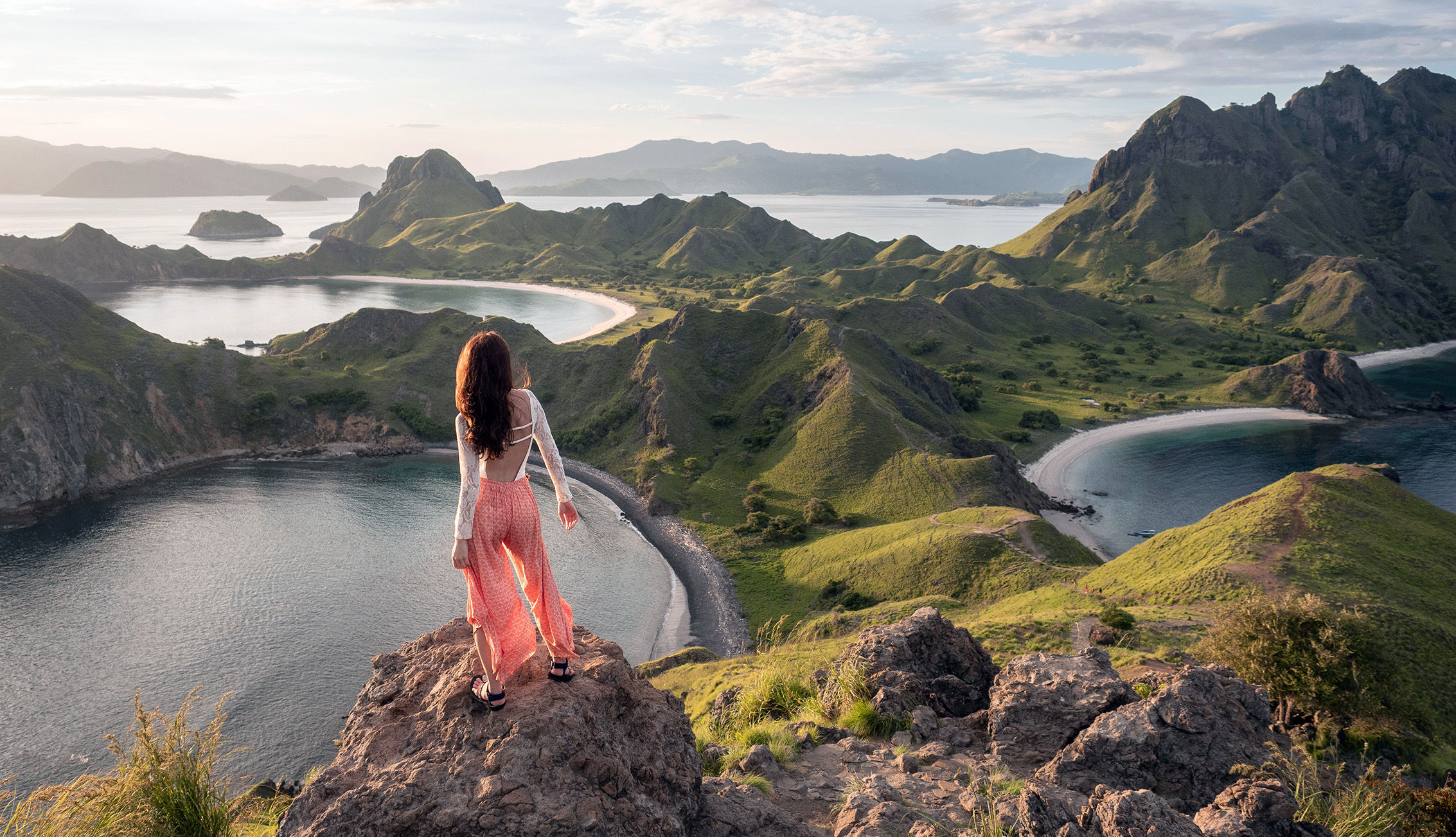 Woman standing on hill top looking at Komodo