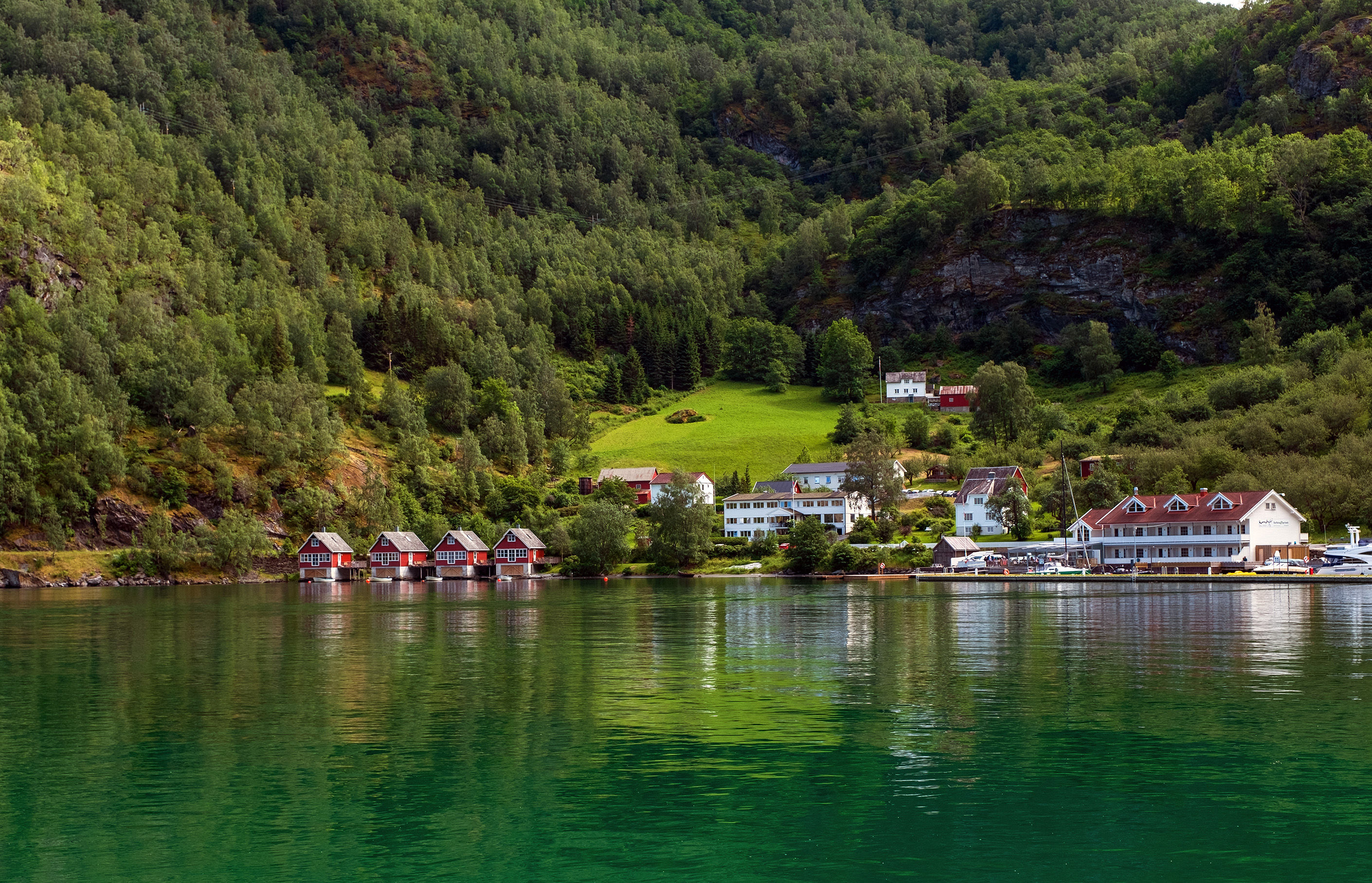 A row of red small house with small boats at Flam, Norway