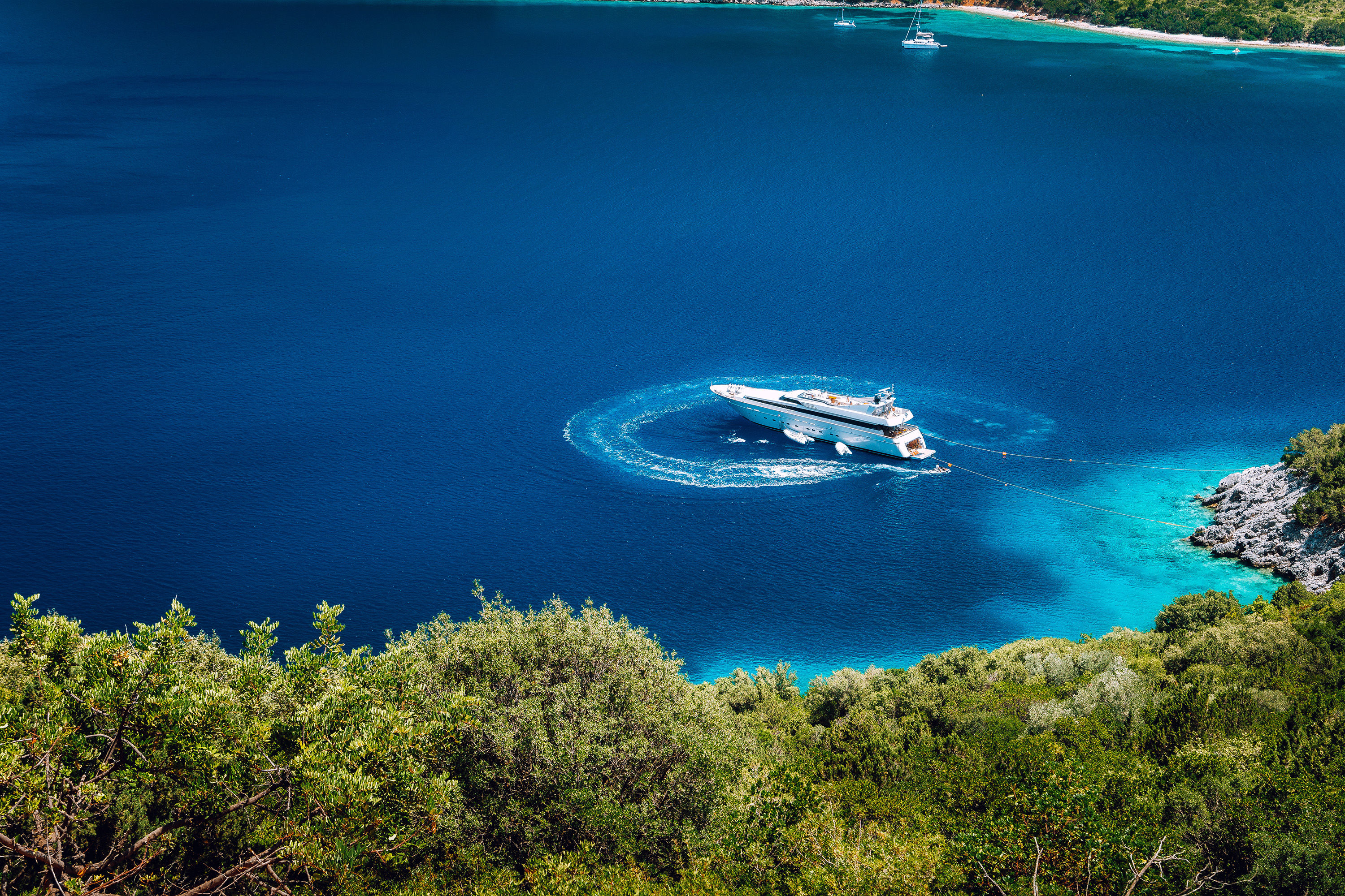Small ship anchored in a tranquil bay in Greece
