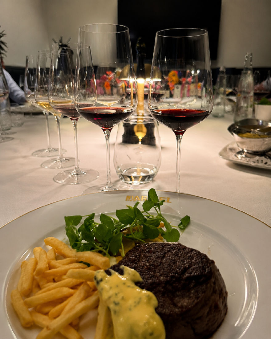 Beef main course with fries and red Barolo at Restaurant Marcel