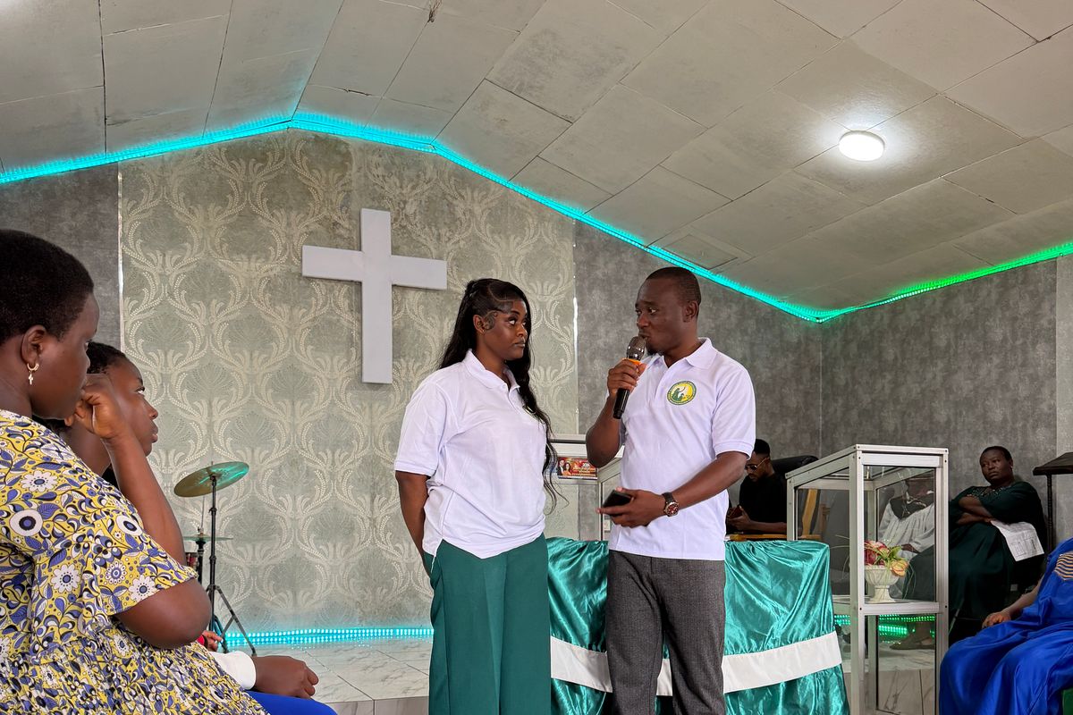 Two Foundation team members speak to participants in the Youth Centre hall