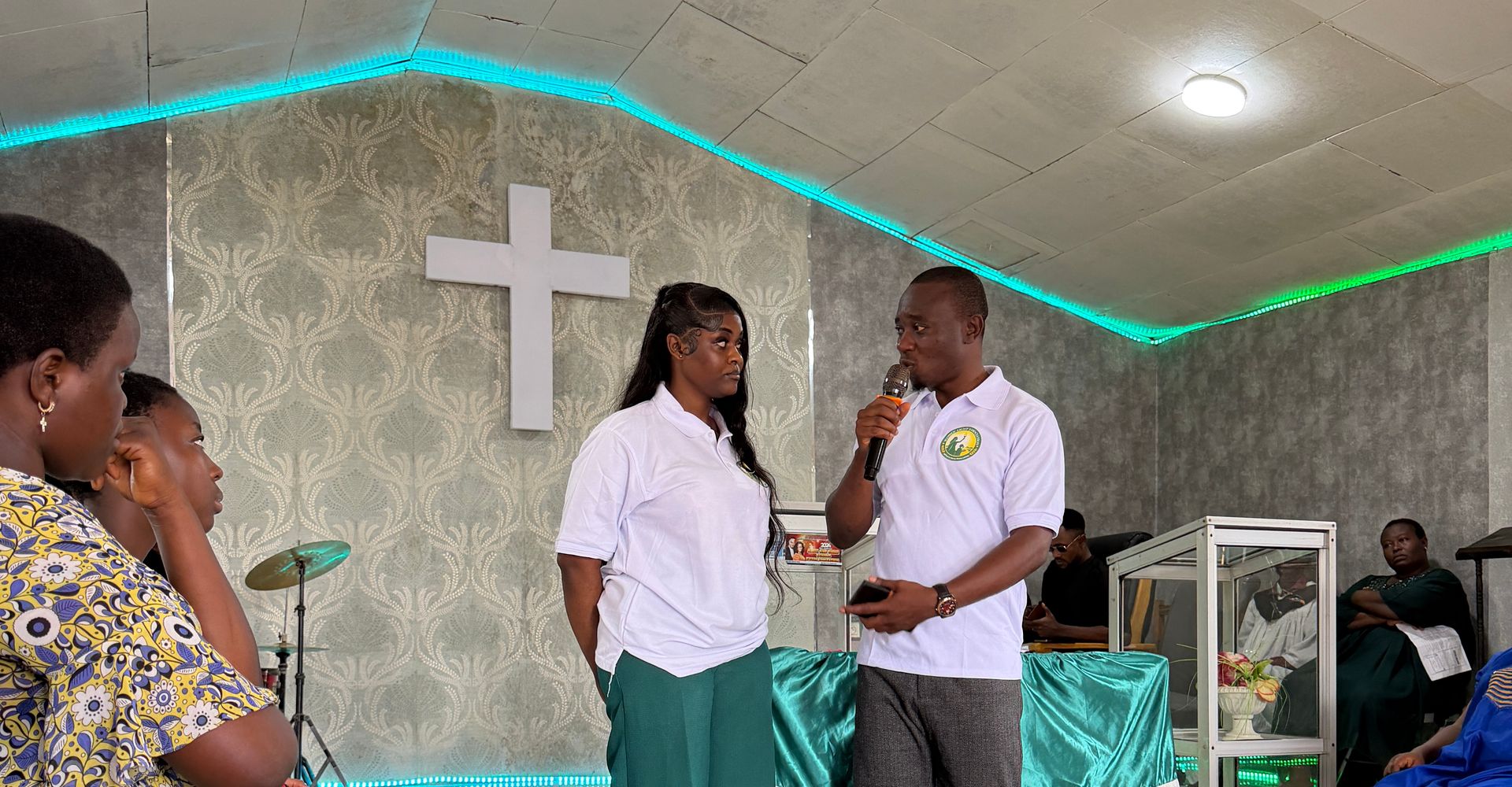 Two Foundation team members speak to participants in the Youth Centre hall