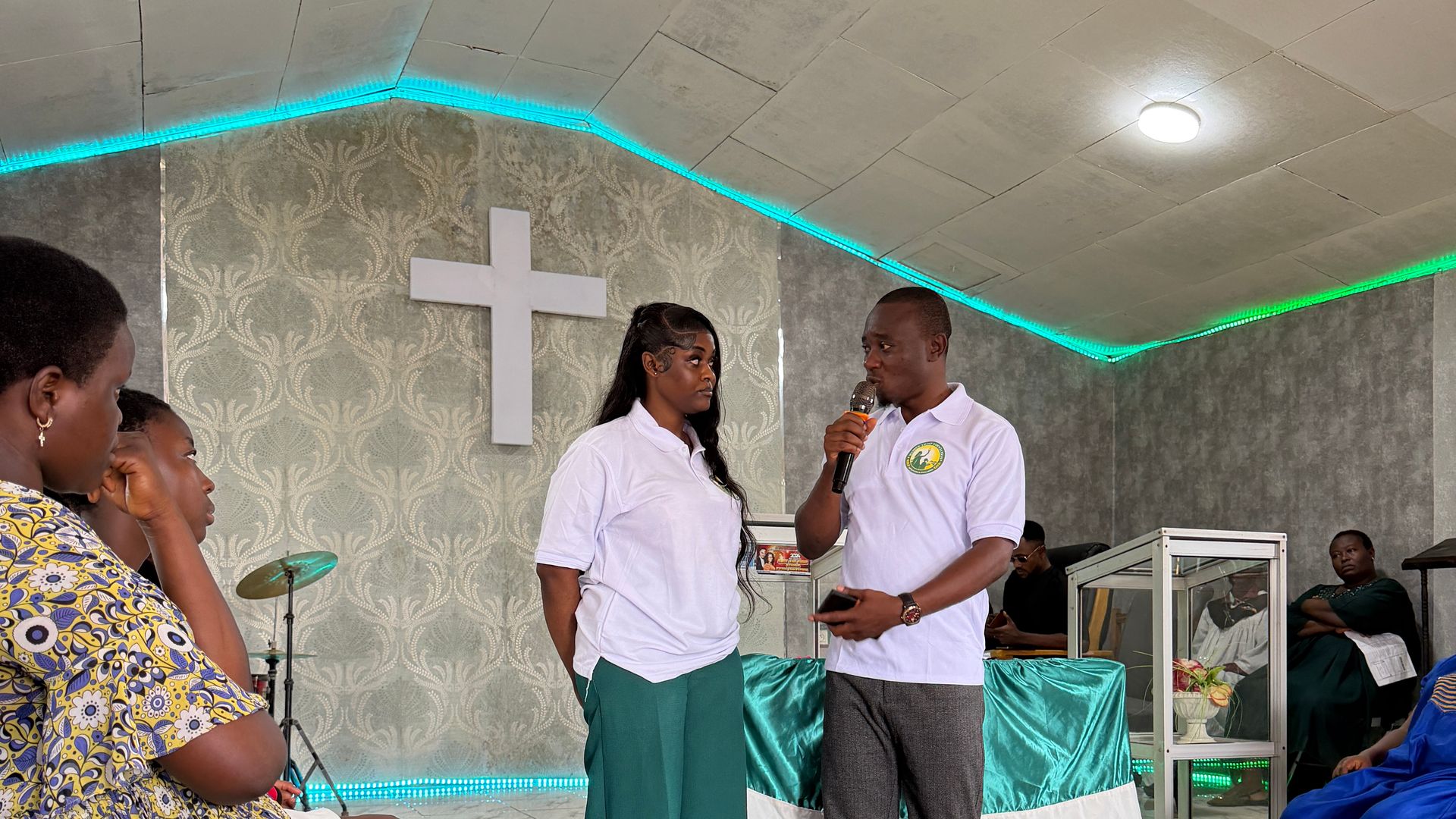 Two Foundation team members speak to participants in the Youth Centre hall