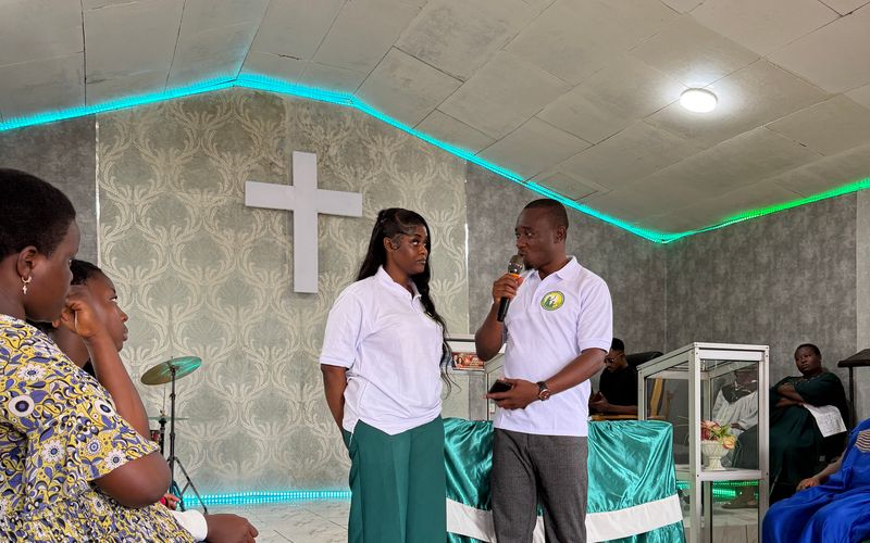 Two Foundation team members speak to participants in the Youth Centre hall