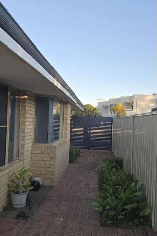 The same side path with the pergola taken down, open to the sky