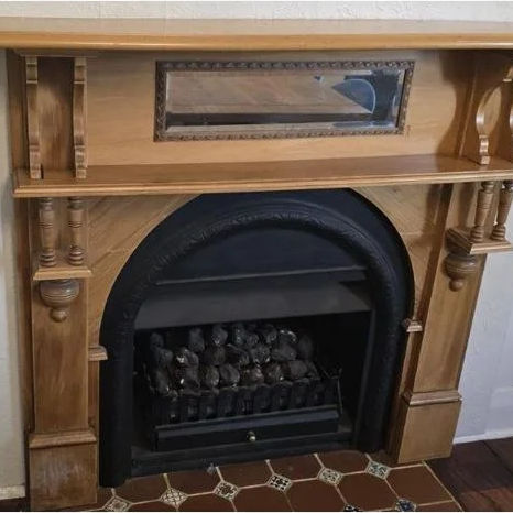 Timber fireplace mantel with a mirror, before removal, in a Perth home
