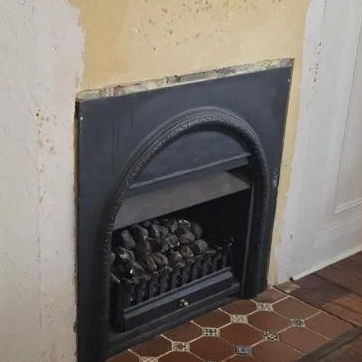 The same fireplace after the mantel came off, left intact