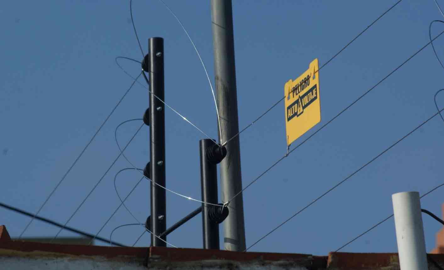Un cerco eléctrico de seguridad con letreros de advertencia