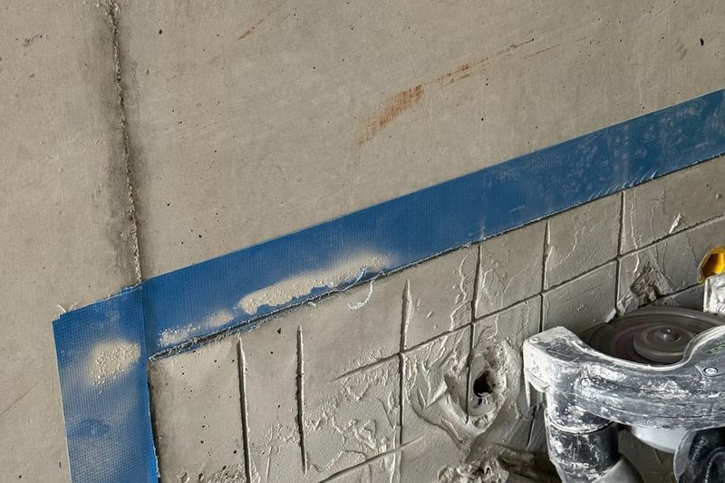 Heritage-trained mason applying color-matched mortar repairs