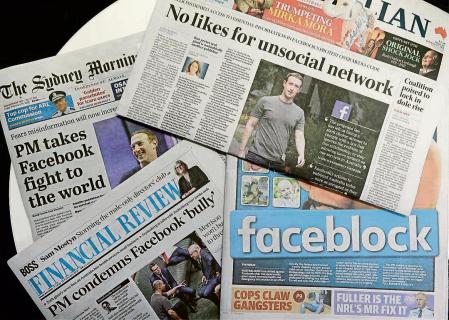 Front pages of Australian newspapers are displayed featuring stories about Facebook in Sydney, Friday, Feb. 19, 2021. In a surprise retaliatory move Thursday, Facebook blocked Australians from sharing news stories, escalating a fight with the government over whether powerful tech companies should have to pay news organizations for content. (AP Photo/Rick Rycroft)