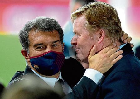 Barcelona's Dutch coach Ronald Koeman (R) celebrates with club president Joan Laporta at the end of the Spanish Copa del Rey (King's Cup) final football match between Athletic Club Bilbao and FC Barcelona at La Cartuja stadium in Seville on April 17, 2021. (Photo by CRISTINA QUICLER / AFP)