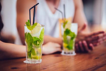 Close-up of mojito cocktail drinks served in tall glasses at summer island beach bar