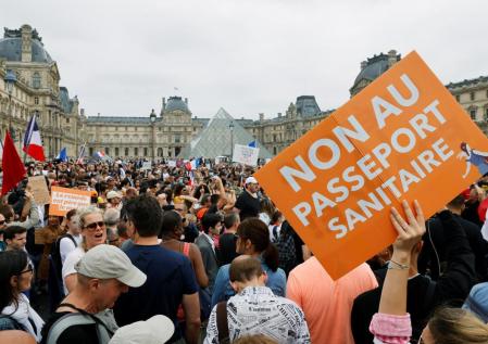 Demonstrators attend a protest against the new measures announced by French President Emmanuel Macron to fight the coronavirus disease (COVID-19) outbreak, in Paris, France, July 17, 2021. REUTERS/Pascal Rossignol