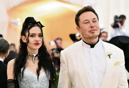 FILE - Grimes, left, and Elon Musk attend The Metropolitan Museum of Art's Costume Institute benefit gala in New York on May 7, 2018. The Tesla and SpaceX founder tells the New York Post that he and the Canadian singer are â#{emoji}128;#{emoji}156;semi-separated.â#{emoji}128;#{emoji}157; But he says they remain on good terms, she still lives at his house in California and they continue to raise their 1-year-old son together. (Photo by Charles Sykes/Invision/AP, File)