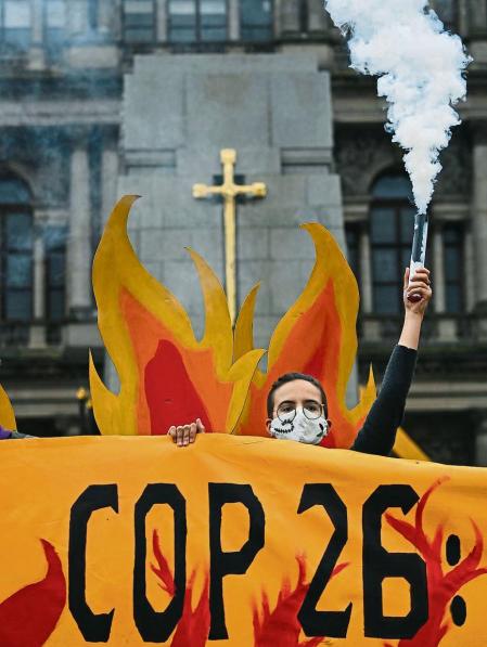 GLASGOW, SCOTLAND - OCTOBER 28: Activists will welcome world leaders to COP26 with a field of climate fire in George Square on October 28, 2021 in Glasgow, Scotland. The group symbolically set George Square â#{emoji}128;#{emoji}156;on fireâ#{emoji}128;#{emoji}157; with an art installation of faux flames, smoke, and banners, showcasing the climate emergency, and massive fire extinguishers highlighting actions world leaders should take at the upcoming COP26 climate negotiations. (Photo by Jeff J Mitchell/Getty Images)