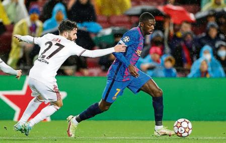 BARCELONA, 23/11/2021.- El delantero francés del FC Barcelona, Ousmane Dembélé (d), se lleva el balón ante el centrocampista del Benfica, Rafa Silva, durante el encuentro correspondiente a la fase de grupos de la Liga de Campeones que disputan hoy martes en el estadio Camp Nou, en Barcelona. EFE / Alberto Estévez.