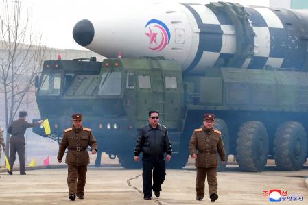 This picture taken on March 24, 2022 and released from North Korea's official Korean Central News Agency (KCNA) on March 25, 2022 shows North Korean leader Kim Jong Un (C) walking near what state media report says a new type inter-continental ballistic missile (ICBM), Hwasongpho-17 of North Korea's strategic forces before its test launch in an undisclosed location in North Korea. (Photo by various sources / AFP) / South Korea OUT / ---EDITORS NOTE--- RESTRICTED TO EDITORIAL USE - MANDATORY CREDIT 