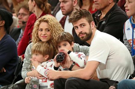 Soccerplayer Gerard Pique and singer Shakira with their sons Milan and Sasha Pique during NBA game in NYC