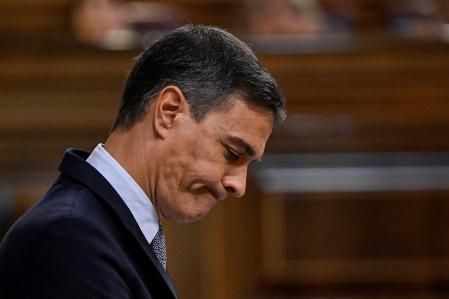 (FILES) Spain's Prime Minister Pedro Sanchez reacts as he delivers a speech during the parliamentary debate on the State of the Nation, at the Congress of Deputies in Madrid on July 12, 2022. Spanish PM on May 29, 2023 has called snap elections in July after Spain's right-wing opposition posted strong gains both locally and regionally in a clear setback for Socialist Prime Minister.  At a local level, the main opposition Popular Party secured the largest number of votes with 90 percent of the ballots counted, while the Socialists lost several regions they held, notably Valencia, media reports said. (Photo by Pierre-Philippe MARCOU / AFP)
