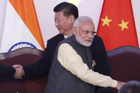 In this Oct. 16, 2016, file photo, Indian Prime Minister Narendra Modi, front and Chinese President Xi Jinping shake hands with leaders at the BRICS summit in Goa, India. Tensions along the China-India border high in the Himalayas have flared again in recent weeks. ÂIndian officials say the latest row began in early May when Chinese soldiers entered the Indian-controlled territory of Ladakh at three different points, erecting tents and guard posts. (AP Photo/Manish Swarup, File)