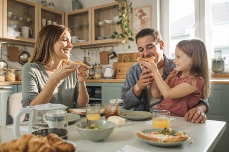 Una familia desayunando en la cocina.