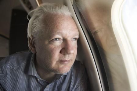 FILE - This screen grab from the X account of Wikileaks shows Julian Assange on board a flight to Bangkok, Thailand, following his release from prison on Tuesday June 25, 2024. The abrupt guilty plea by WikiLeaks founder Julian Assange was the culmination of negotiations that began a year and a half ago and accelerated in recent months.(@WikiLeaks, via AP)
