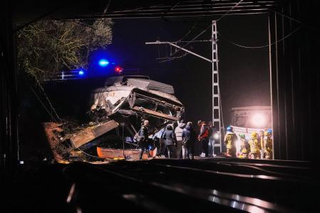 Emergency crews respond after a commuter train derailed when a retaining wall collapsed onto the tracks in Gelida, near Barcelona
