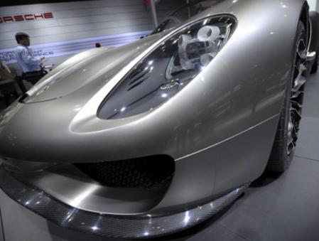 Un visitante observa el Porsche 918 Spyder, en uno de los stand del Salón del Automóvil de Pekín 2010