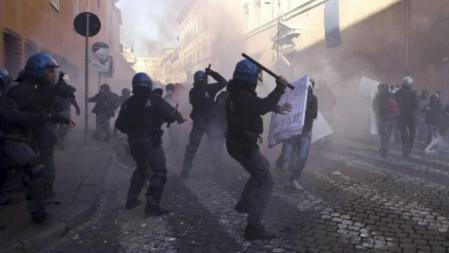 Agentes de la Policía italiana cargan contra los manifestantes que protestaron contra el Gobierno de Silvio Berlusconi, durante los duros enfrentamientos ocurridos ante la sede del Senado y la plaza Venecia, en el centro de Roma (Italia), hoy, martes 14 de diciembre de 2010. Los agentes cargaron duramente contra varios centenares de estudiantes que intentaron atravesar el cordón policial instalado en torno al Palacio Madama, sede del Senado, después de que éstos lanzaran piedras, petardos, botes de humo y pintura contra la sede de la cámara alta. Miles de personas se manifiestaron hoy en las principales ciudades de Italia para protestar contra el Gobierno de Silvio Berlusconi, quien se juega su futuro en la Cámara de los Diputados, donde su Ejecutivo afronta dos mociones de censura.