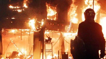 Un agente observa uno de los incendios en Tottenham