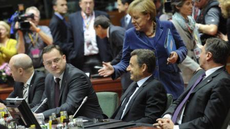 La canciller alemana, Angela Merkel, habla con el presidente francés, Nicolas Sarkozy, y otros primeros ministros europeos durante la cumbre de Bruselas