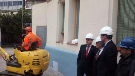 Germà Gordó, Xavier Trias y Antoni Vives observan la labor del percutor durante el acto institucional de inicio del derribo del Centro Abierto de La Model