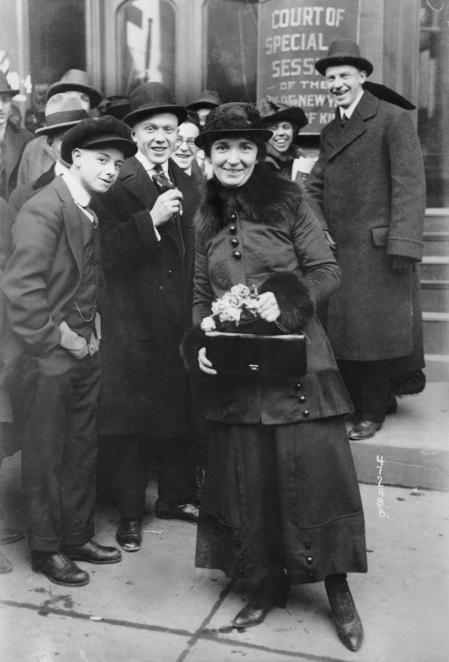 Social activist Margaret Sanger stands outside a court of special sessions where she is on trial for her teachings on birth control.