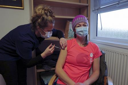 FALMOUTH, ENGLAND - DECEMBER 20: Dr Emmie Carter, GP, attends the Falmouth Health Centre for her first Covid-19 vaccination on December 20, 2020 in Falmouth, England. The UK is in the second week of its covid-19 vaccination campaign, as the country struggles to halt the spread of the virus. Rising infection rates in southern England forced the government to scrap a 5-day window for household mixing over Christmas. (Photo by Hugh Hastings/Getty Images)