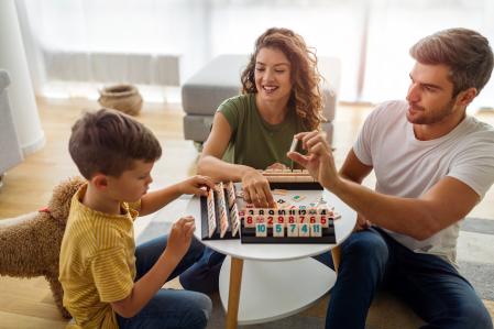 Happy family having fun, playing board game at home, happiness concept. People pet love concept.