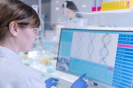 Scientists examines DNA models in modern Genetic Research Laboratory. Looking through laboratory glassware