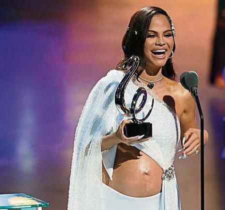 Natti Natasha accepts the award for tropical song of the year for 