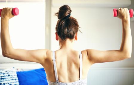 Attractive fit woman doing workout at home.