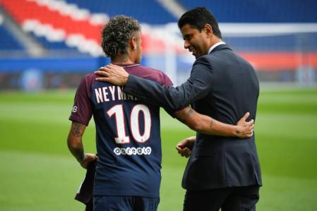 (FILES) In this file photo taken on August 4, 2017 Brazilian superstar Neymar (L) wearing his new jersey talks to Paris Saint Germain's (PSG) Qatari president Nasser Al-Khelaifi during his official presentation at the Parc des Princes stadium on in Paris after agreeing a five-year contract following his world record 222 million euro ($260 million) transfer from Barcelona to PSG. - With a bling-bling image, repeated crises and outstanding successes: officially born on August 12, 1970 in order to become the 